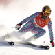 A downhill skier turning and spraying snow.